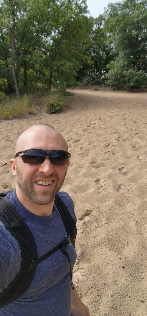Photo of the author about to hike up a steep sand hill.