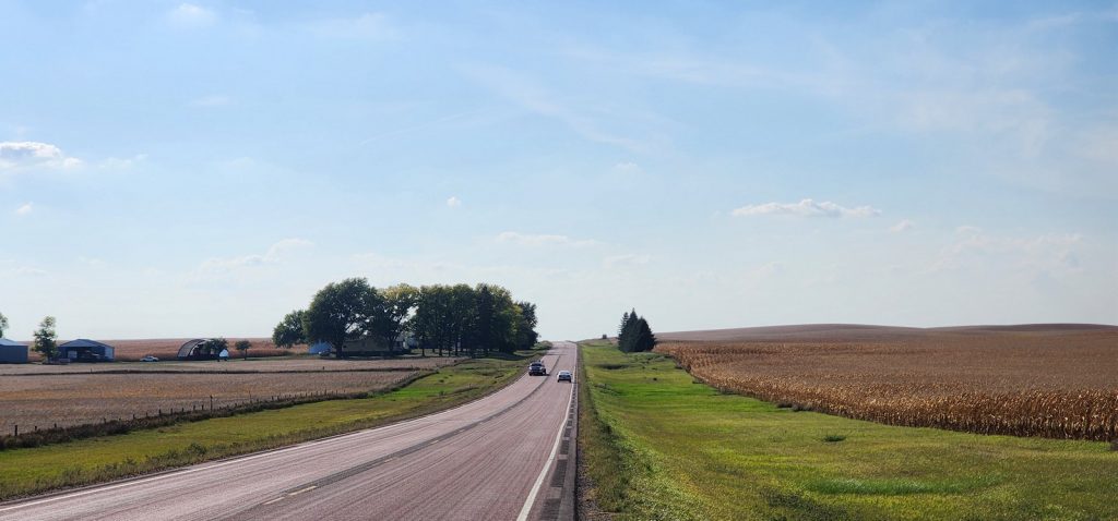 Photo of farmland sandwiching a road.